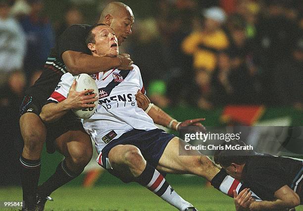 Craig Fitzgibbon of the Roosters is tackled high by Frank Puletua of the Panthers during the NRL round 20 match betwen the Penrith Panthers and the...