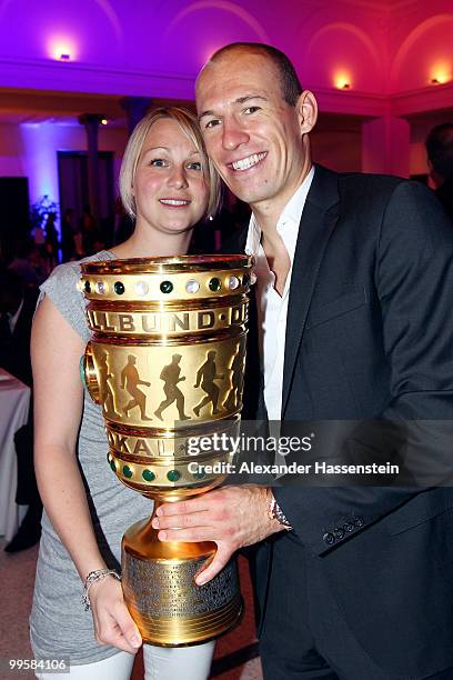 Arjen Robben and his wife Bernadien pose with the trophy during the Bayern Muenchen Champions Party after the DFB Cup Final match against Werder...