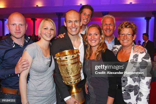 Arjen Robben pose with the trophy together with his family the Bayern Muenchen Champions Party after the DFB Cup Final match against Werder Bremen at...