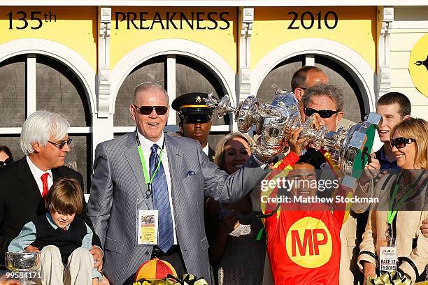 Jockey Martin Garcia celebrates in the winners circle after riding Lookin at Lucky to win during the 135th Preakness Stakes at Pimlico Race Course on...