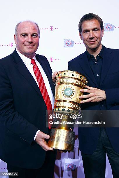 Uli Hoeness, president of Bayern and Rene Obermann, CEO of the Deutsche Telekom pose with the trophy during the Bayern Muenchen Champions Party after...