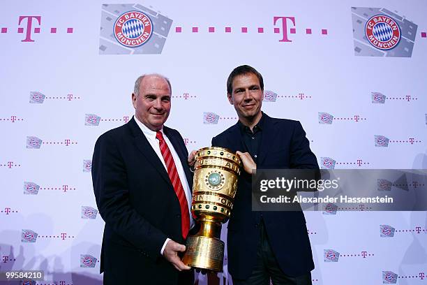 Uli Hoeness, president of Bayern and Rene Obermann, CEO of the Deutsche Telekom pose with the trophy during the Bayern Muenchen Champions Party after...