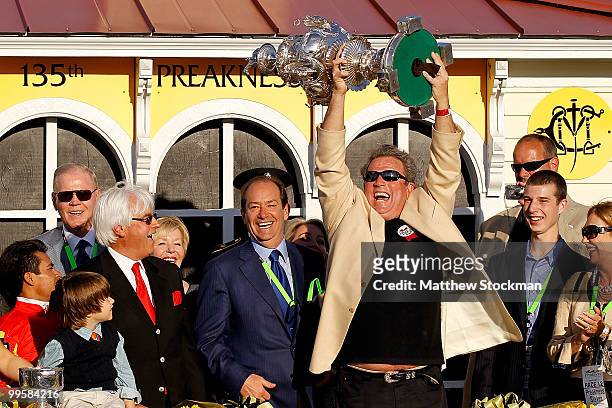 Owner Michael Pegram celebrates in the winners circle after his horse Lookin at Lucky wins the 135th Preakness Stakes at Pimlico Race Course on May...