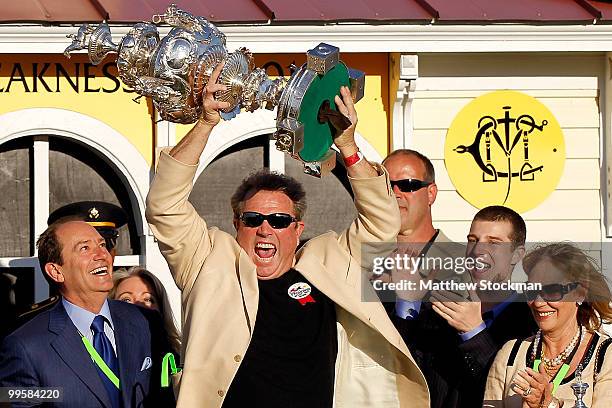 Owner Michael Pegram celebrates in the winners circle after his horse Lookin at Lucky wins the 135th Preakness Stakes at Pimlico Race Course on May...