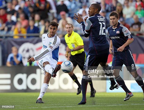 Chris Wondolowski of the San Jose Earthquakes shoots on net against Cory Gibbs of the New England Revolution in front of the net at Gillette Stadium...