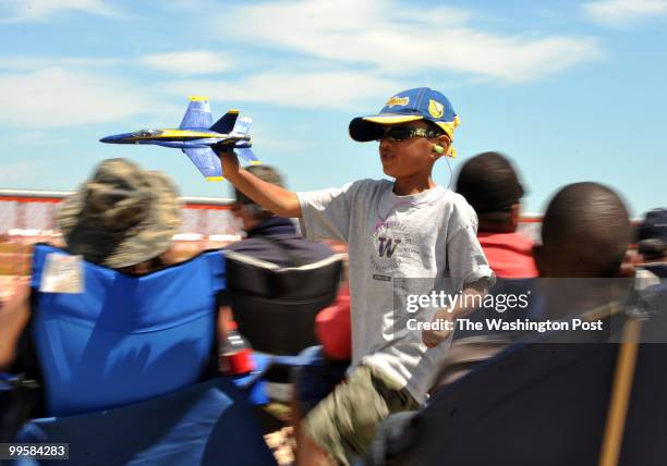 Henry Nichols from Philadelphia, PA, plays with his toy Blue Angels jet at the 2010 Joint Service Open House and air show at Andrews Air Force Base...