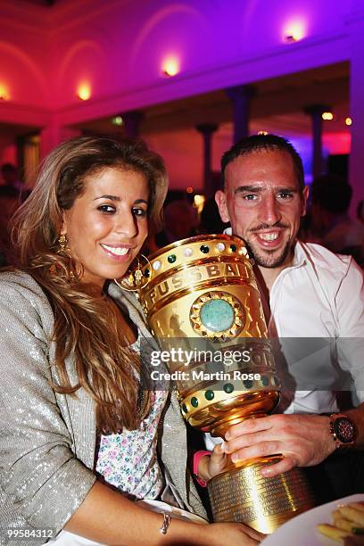 Franck Ribery and his wife Wahiba pose with the DFB Cup trophy during the Bayern Muenchen Champions Party after the DFB Cup Final match against...