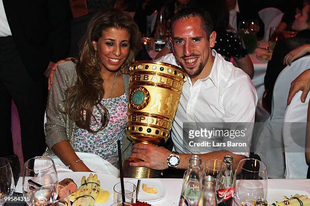 Franck Ribery and his wife Wahiba pose with the DFB Cup trophy during the Bayern Muenchen Champions Party after the DFB Cup Final match against...