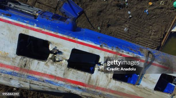 View of a derailed carriage, waiting for removal, after several bogies of a passenger train derailed at the Sarilar village in Corlu district of...