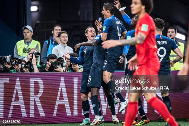 Antoine Griezmann celebrates with team mates their teams first goal scored by Samuel Umtiti during the 2018 FIFA World Cup Russia Semi Final match...