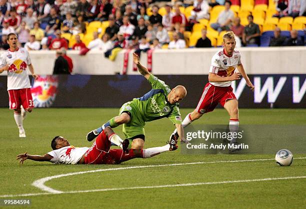 Danleigh Borman of the New York Red Bulls and Freddie Ljungberg of the Seattle Sounders FC fight for position on a loose ball during their game at...