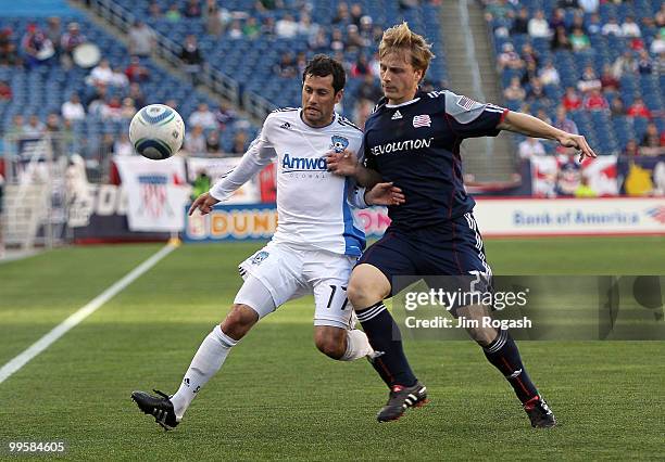 Joey Gjertsen of the San Jose Earthquakes battles against Seth Sinovic of the New England Revolution in front of the net at Gillette Stadium on May...