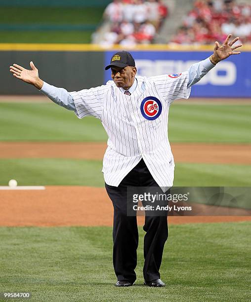 Ernie Banks waves to the crowd after throwing out the first pitch before the Gillette Civil Rights Game between the Cincinnati Reds and the St. Louis...