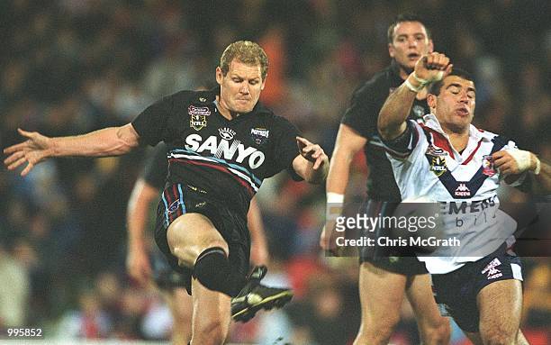 Steve Carter of the Panthers gets a kick away under pressure during the NRL round 20 match betwen the Penrith Panthers and the Sydney Roosters held...