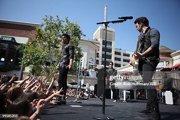 Joe Jonas, Nick Jonas and Kevin Jonas of Jonas Brothers perform at The Grove on May 15, 2010 in Los Angeles, California.