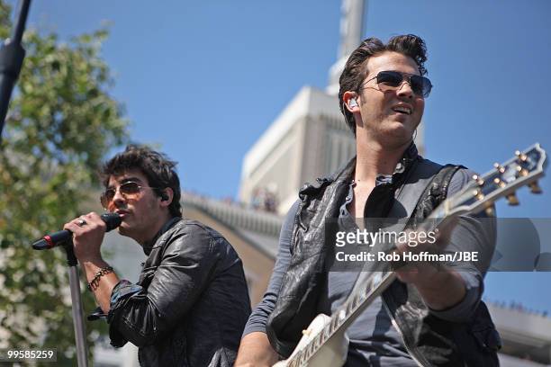 Joe Jonas and Kevin Jonas of Jonas Brothers perform at The Grove on May 15, 2010 in Los Angeles, California.