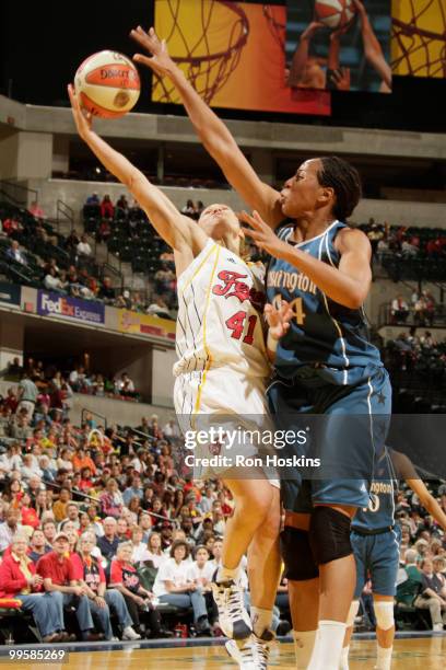 Tully Bevilaqua of the Indiana Fever gets her shot blocked by Chasity Melvin of the Washington Mystics at Conseco Fieldhouse on May 15, 2010 in...