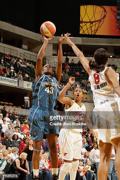 Nakia Sanford of the Washington Mystics shoots over Tammy Sutton-Brown and Tamika Catchings of the Indiana Fever at Conseco Fieldhouse on May 15,...