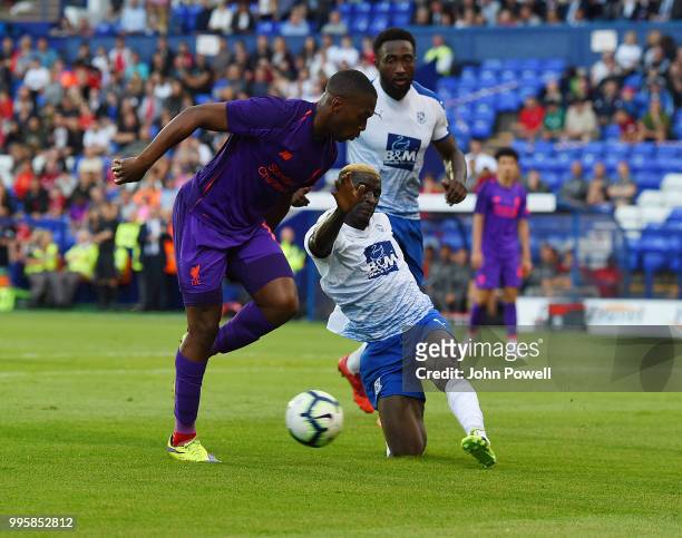 Daniel Sturridge of Liverpool competes with Ollie Norburn of Tranmere Rovers during the pre-season friendly match between Tranmere Rovers and...