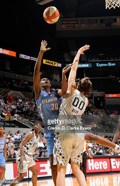 Sancho Lyttle of the Atlanta Dream shoots over Ruth Riley of the Silver Stars during the game at AT&T Center on May 15, 2010 in San Antonio, Texas....