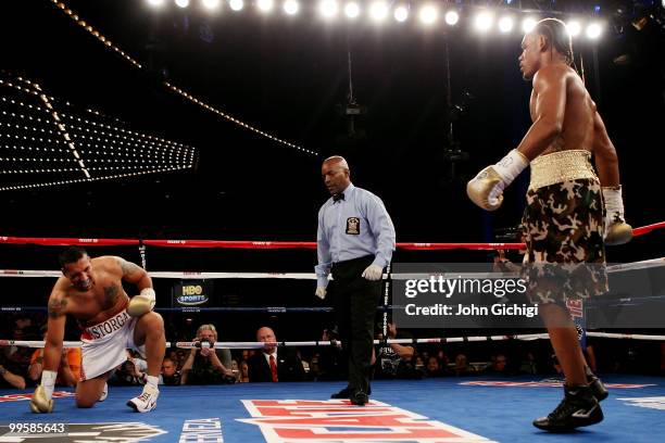 Danny Jacobs knocks down Juan Astorga as referee Steve Willis looks on during the NABO supermiddleweight championship fight at Madison Square Garden...