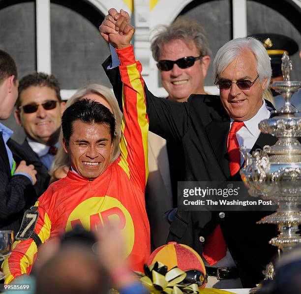 Jockey Martin Garcia and Trainer Bob Baffert celebrate in the winners circle after Lookin At Lucky won the 135th running of the Preakness Stakes at...