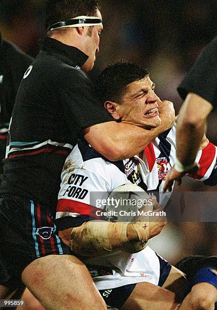 Michael Korkidas of the Roosters is tackled high by Craig Greenhill of the Panthers during the NRL round 20 match betwen the Penrith Panthers and the...