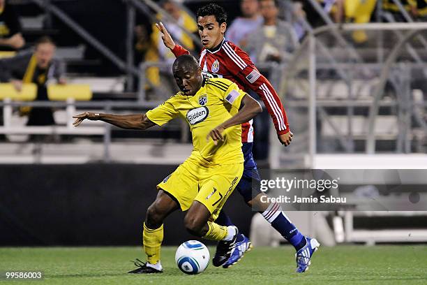 Emmanuel Ekpo of the Columbus Crew holds off Jesus Padilla of Chivas USA as he controls the ball on May 15, 2010 at Crew Stadium in Columbus, Ohio.