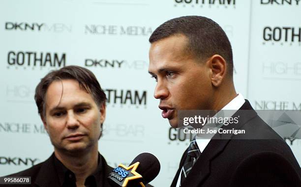 And founder of Niche media Jason Binn looks on while New York Yankee third baseman Alex Rodriguez speaks to Access Hollywood during the Gotham...