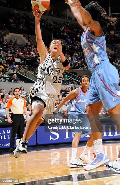 Becky Hammon of the San Antonio Silver Stars shoots against Angel McCoughtry of the Atlanta Dream during the game at AT&T Center on May 15, 2010 in...