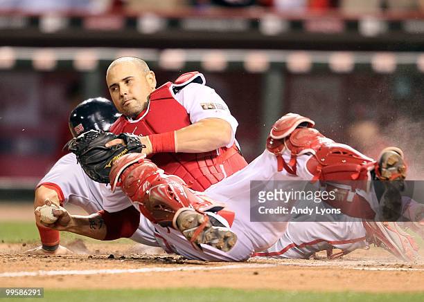 Ramon Hernandez of the Cincinnati Reds holds on to the ball after tagging out Skip Schumaker of the St. Louis Cardinals to end the Gillette Civil...