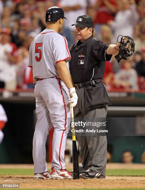 Albert Pujols of the St. Louis Cardinals and home plate umpire Rob Drake share a few words after Pujols struck out during the Gillette Civil Rights...