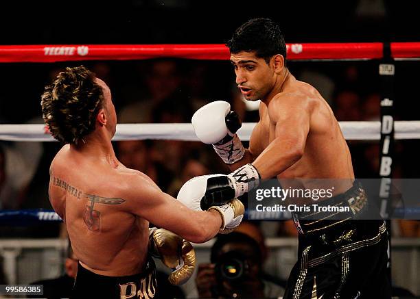 Amir Khan of Great Britain hits Paulie Malignaggi during the WBA light welterweight title fight at Madison Square Garden on May 15, 2010 in New York...