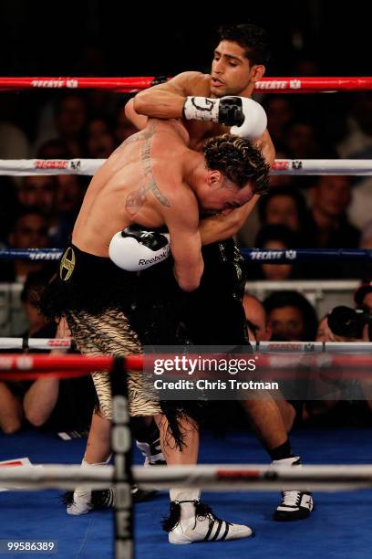 Amir Khan of Great Britain exchanges blows against Paulie Malignaggi during the WBA light welterweight title fight at Madison Square Garden on May...