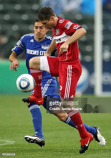 Logan Pause of the Chicago Fire controls the ball as Davy Arnaud of the Kansas City Wizards gives chase during the game on May 15, 2010 at Community...