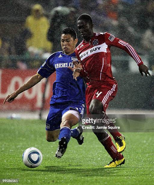 Roger Espinoza of the Kansas City Wizards slides battles Patrick Nyarko of the Chicago Fire for the ball during the game on May 15, 2010 at Community...