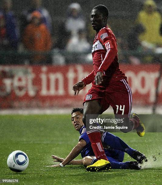 Roger Espinoza of the Kansas City Wizards slides as Patrick Nyarko of the Chicago Fire controls the ball during the game on May 15, 2010 at Community...