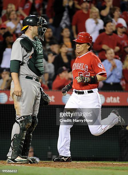 Hideki Matsui of the Los Angeles Angels scores a run for a 8-3 lead in front of Landon Powell of the Oakland Athletics during the sixth inning at...
