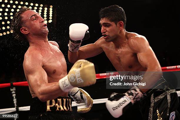 Amir Khan of Great Britain hits Paulie Malignaggi during the WBA light welterweight title fight at Madison Square Garden on May 15, 2010 in New York...