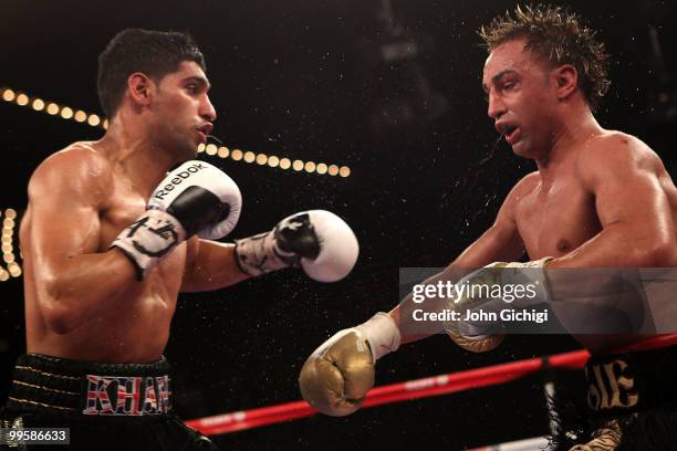 Amir Khan of Great Britain and Paulie Malignaggi exchange blows during the WBA light welterweight title fight at Madison Square Garden on May 15,...
