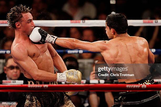 Amir Khan of Great Britain hits Paulie Malignaggi during the WBA light welterweight title fight at Madison Square Garden on May 15, 2010 in New York...