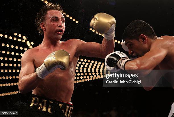 Amir Khan of Great Britain and Paulie Malignaggi exchange blows during the WBA light welterweight title fight at Madison Square Garden on May 15,...