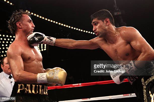 Amir Khan of Great Britain hits Paulie Malignaggi during the WBA light welterweight title fight at Madison Square Garden on May 15, 2010 in New York...