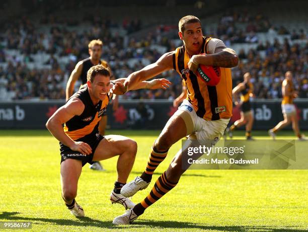 Lance Franklin of the Hawks brushes off the tackle from Nathan Foley of the Tigers during the round eight AFL match between the Richmond Tigers and...