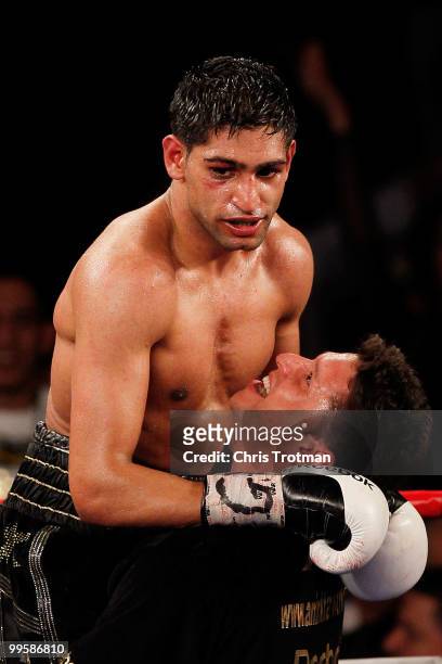 Amir Khan of Great Britain celebrates with a trainer after defeating Paulie Malignaggi by TKO in the 11th round of his WBA light welterweight title...