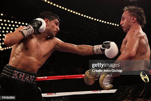 Amir Khan of Great Britain connect with a left to the face of Paulie Malignaggi during the WBA light welterweight title fight at Madison Square...