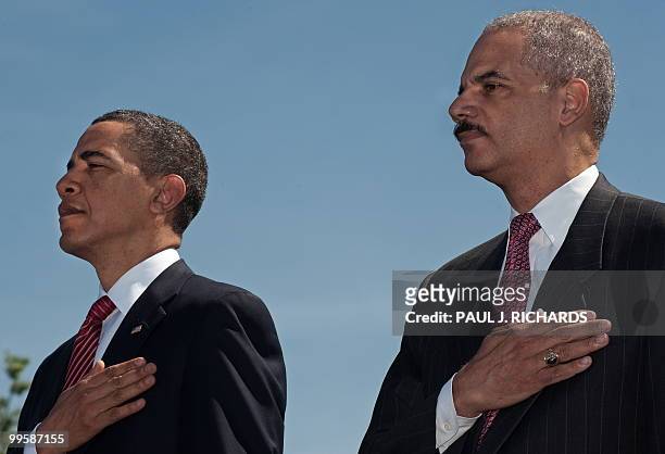 President Barack Obama and US Attorney General Eric Holder hold their hands over their heart during the advancement of colors at start of the...