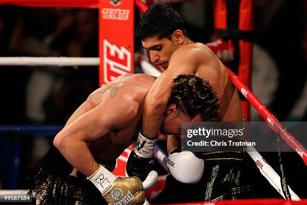 Amir Khan of Great Britain and Paulie Malignaggi exchange blows during the WBA light welterweight title fight at Madison Square Garden on May 15,...