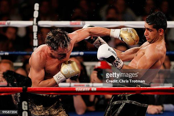 Paulie Malignaggi hits Amir Khan of Great Britain hits during the WBA light welterweight title fight at Madison Square Garden on May 15, 2010 in New...