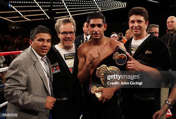 Manager Asif Vali, trainer Freddie Roach, Amir Khan of Great Britain and Alex Ariza celebrate after winning their WBA light welterweight title fight...